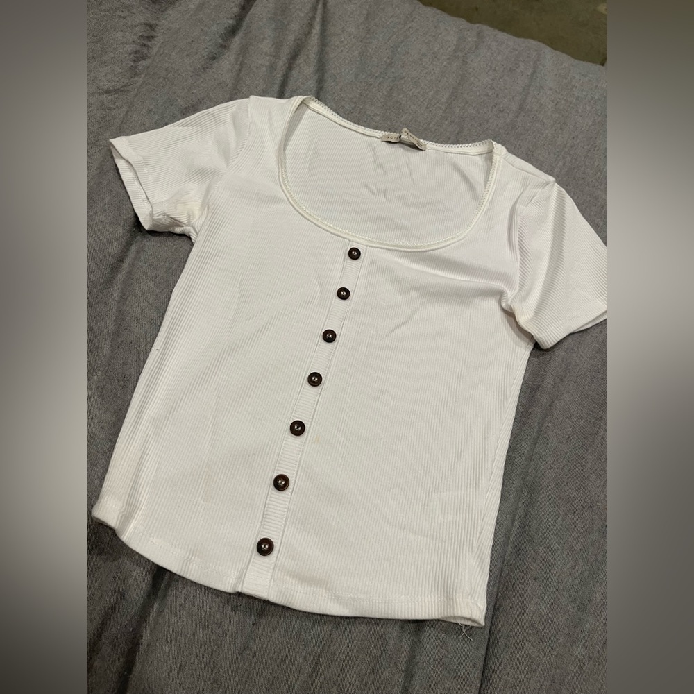 Orange/tan long sleeve. White tube top. White button down tee.